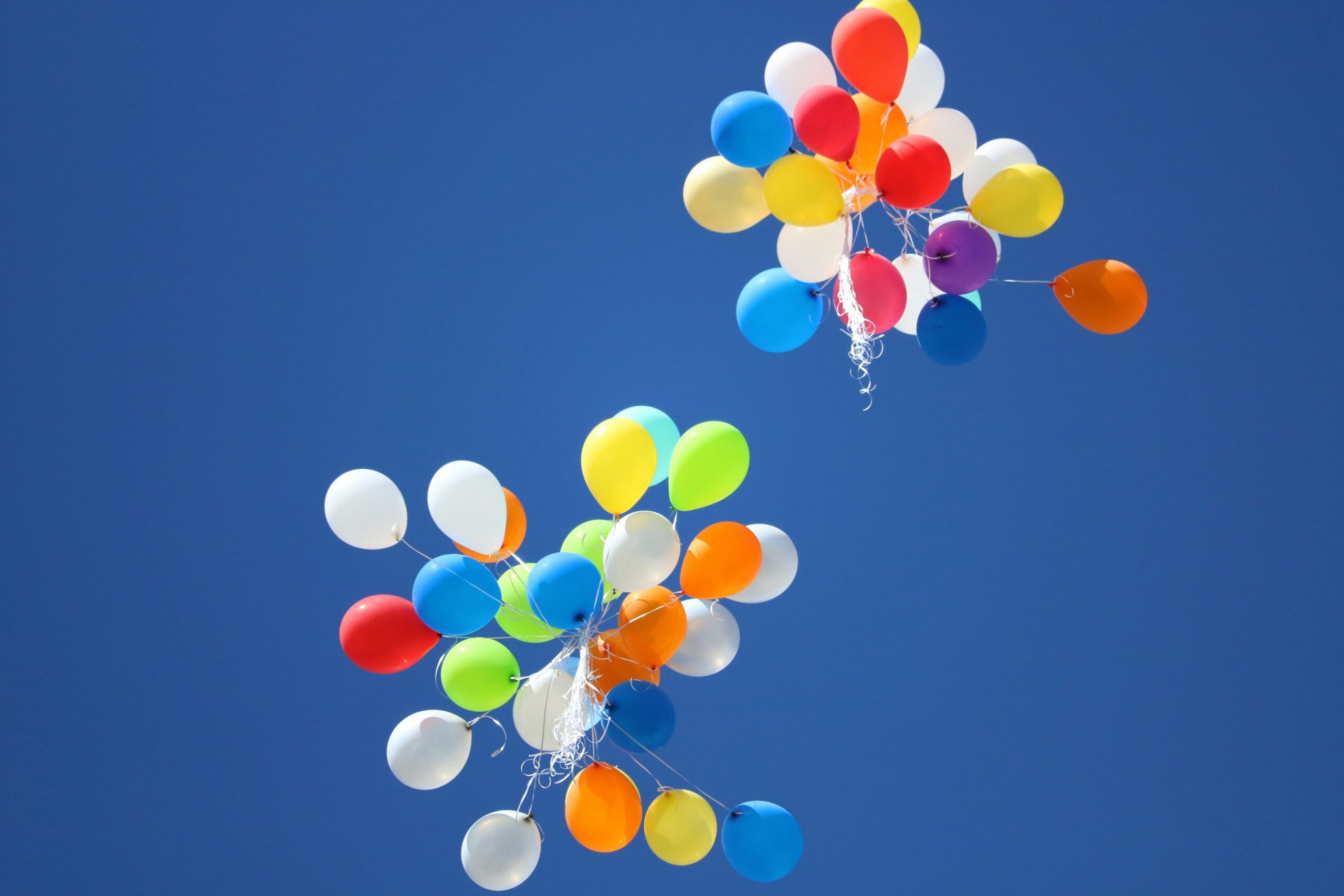 Colorful balloons against a blue sky. Symbolic of celebration.