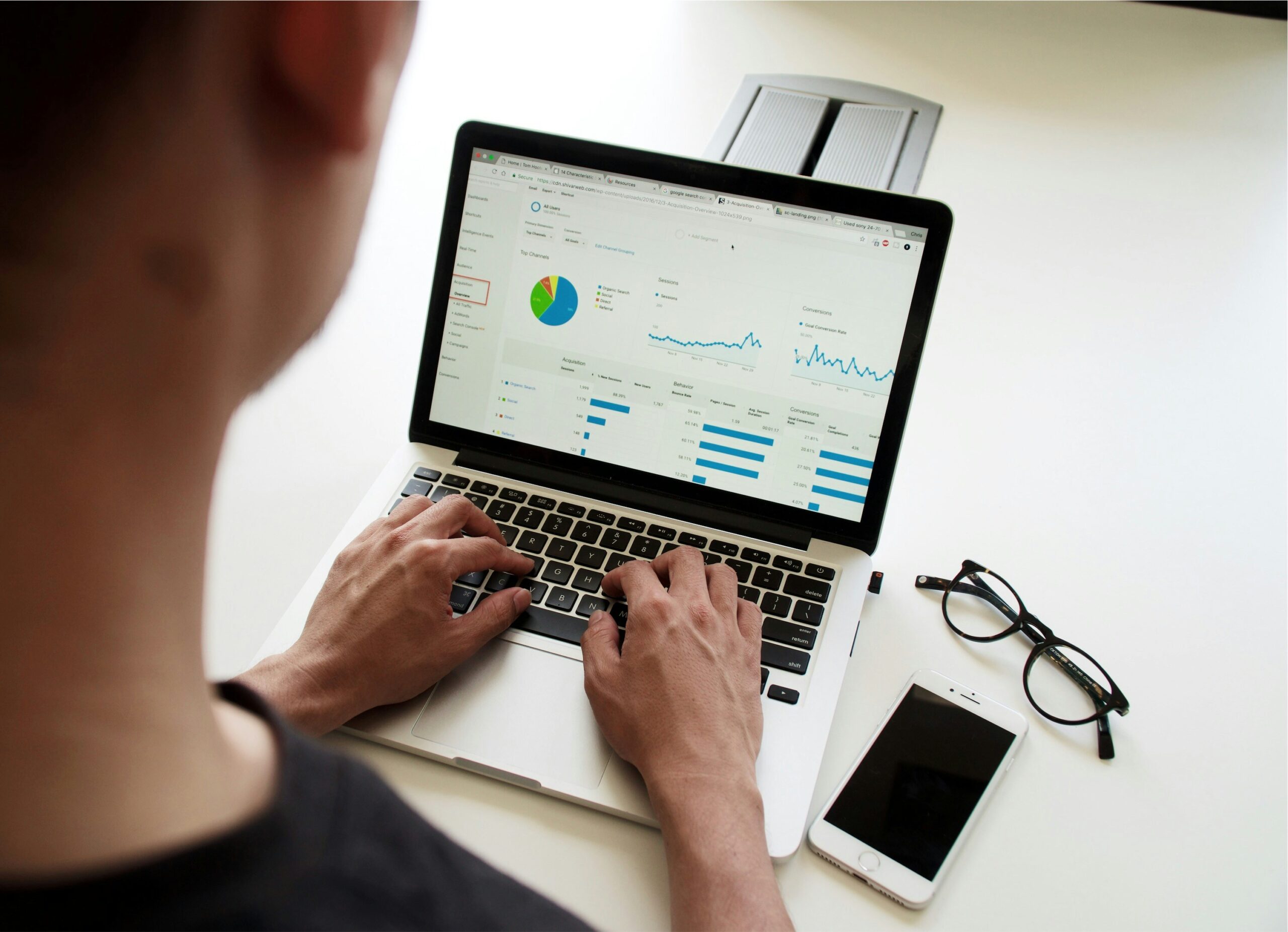 Person working on a laptop, viewing marketing data and analytics.