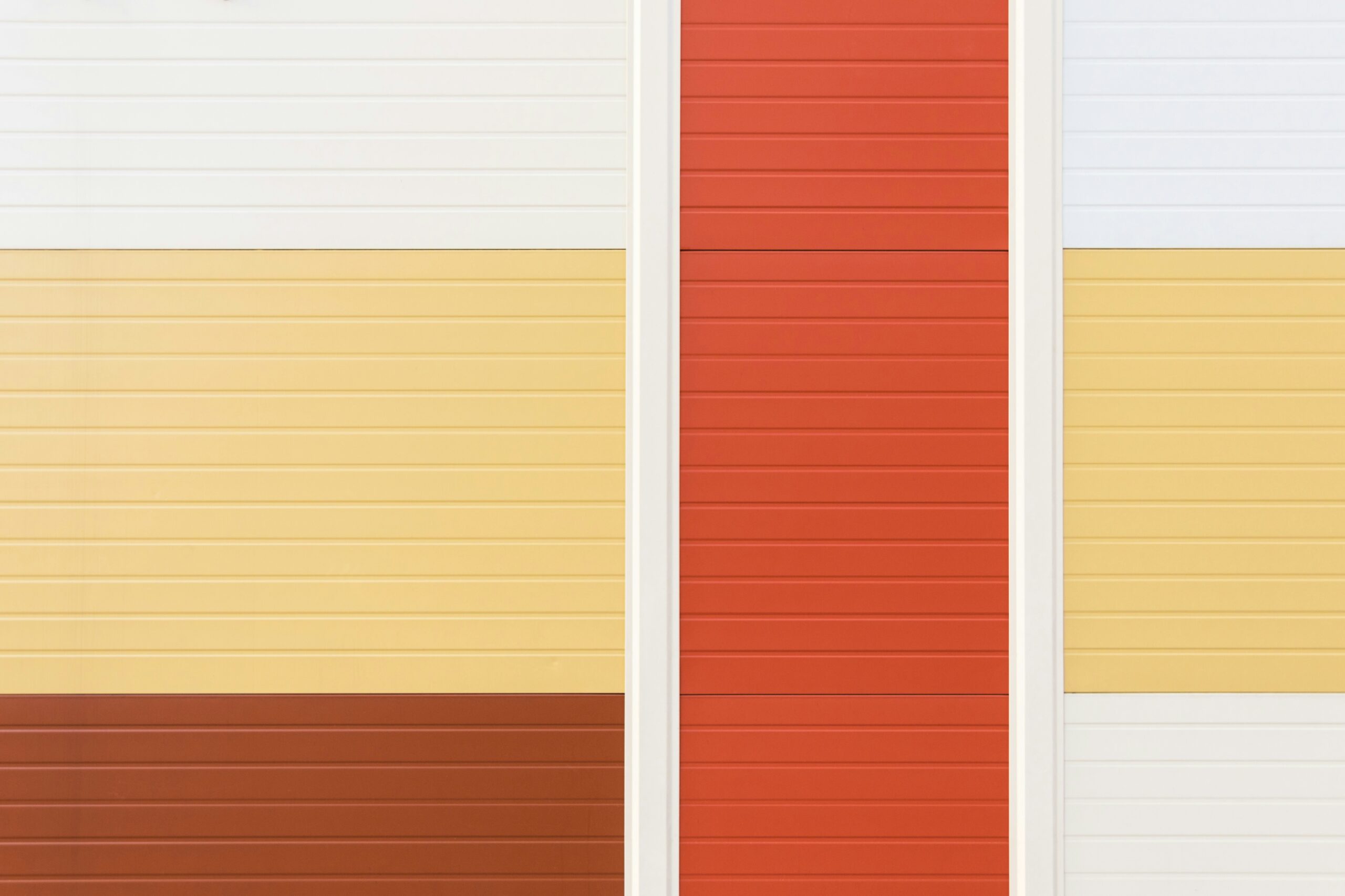 Abstract colorful wall design with red, yellow, white, and brown panels.