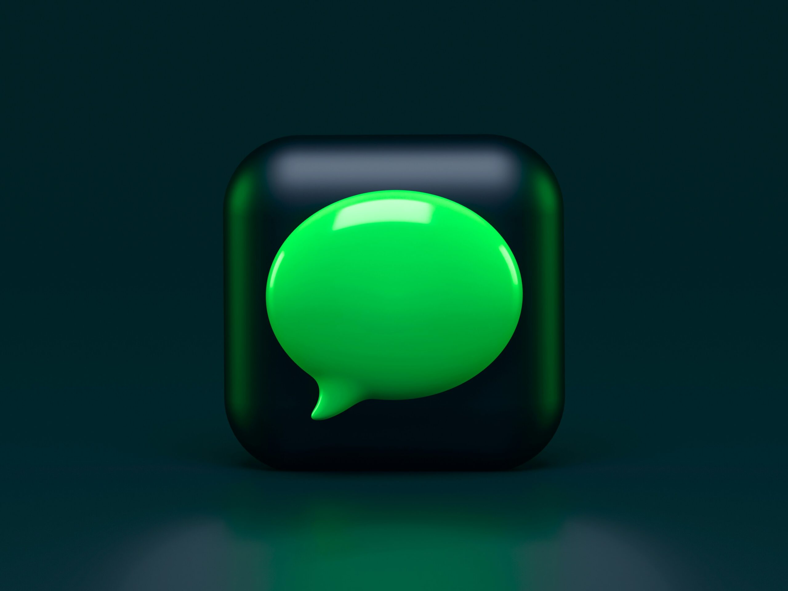 Green speech bubble icon on a black background, indicating messaging or communication.