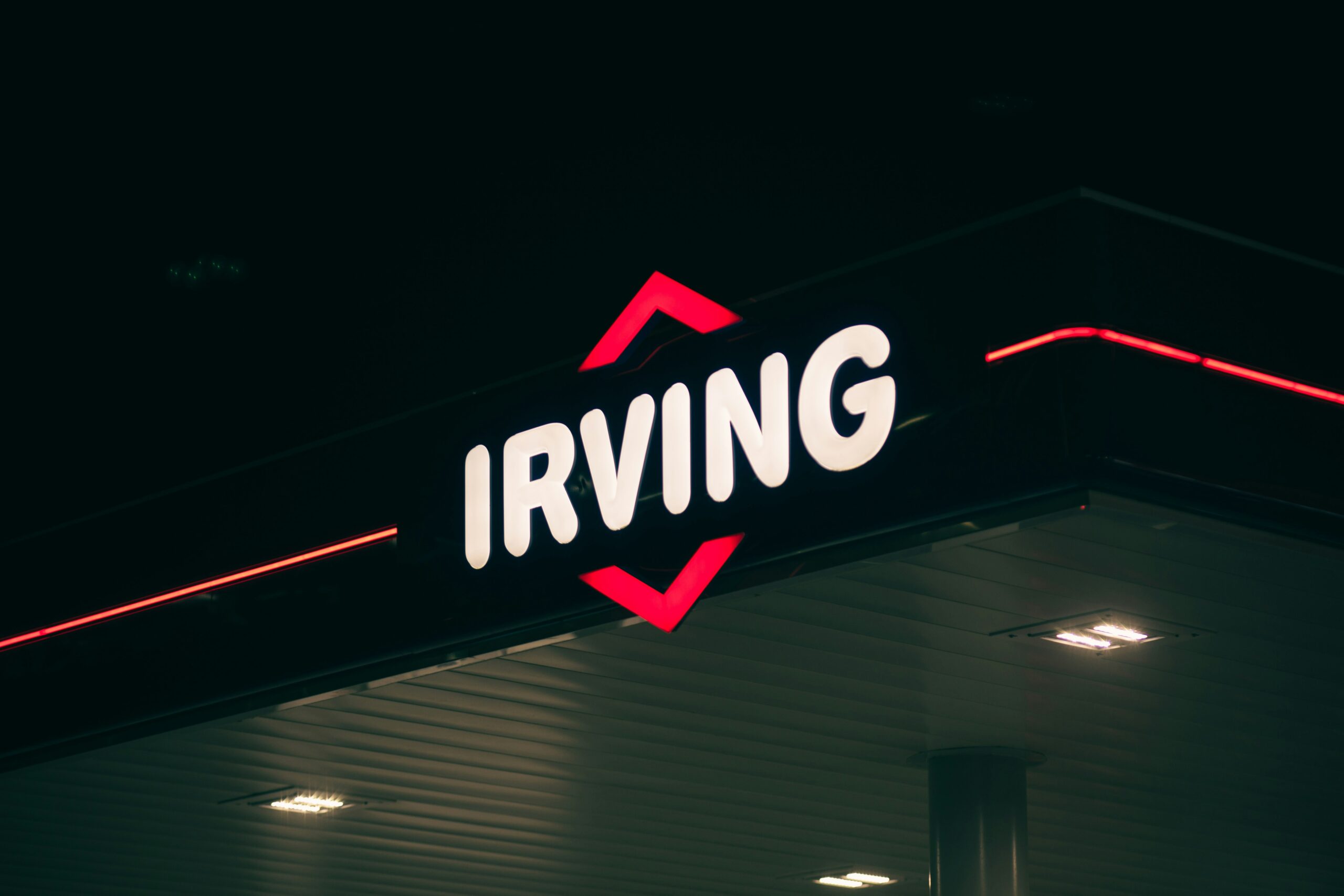 Irving gas station sign at night.