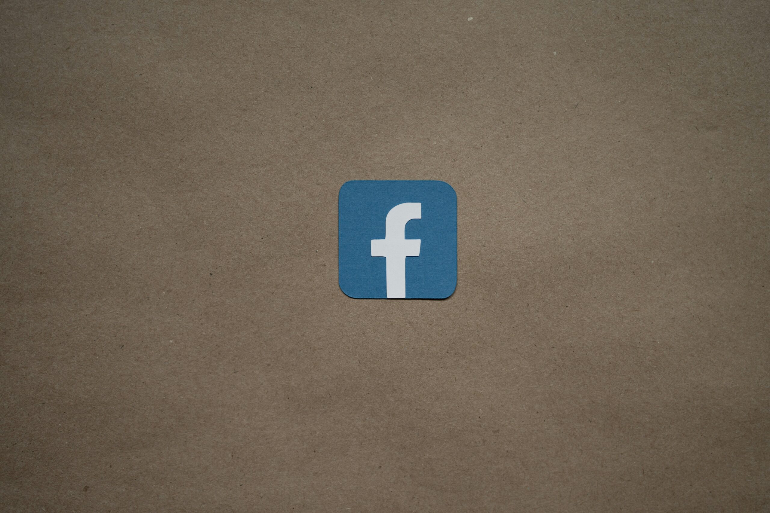 Facebook logo on brown background. Related to Facebook Ads and Instagram Ads.