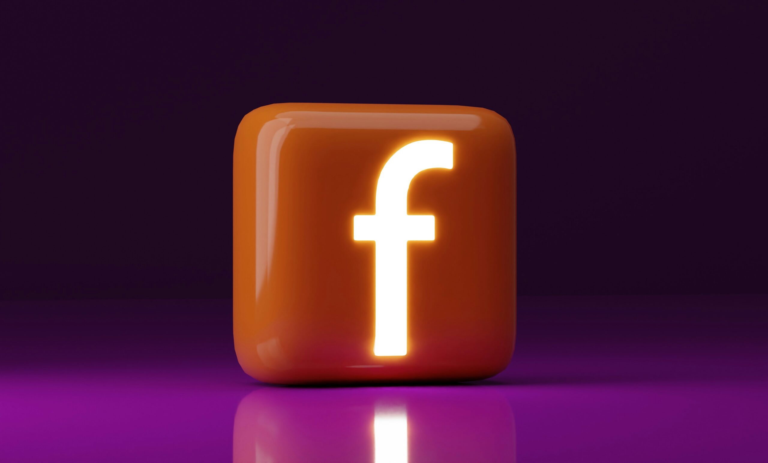 Orange 3D Facebook logo on a purple background, perfect for Facebook Ads and digital marketing.