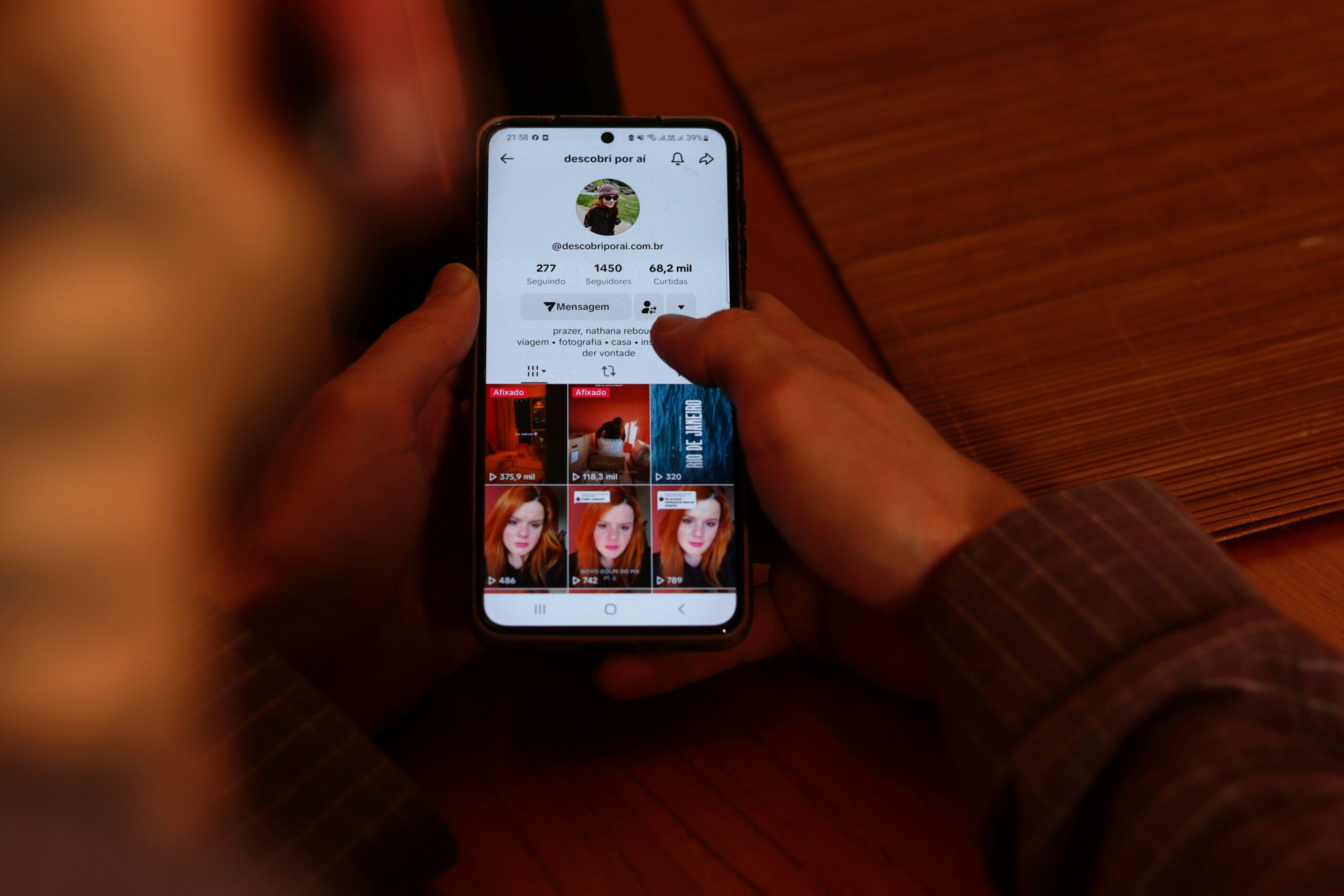 Person using a social media app on a smartphone. Shows a profile page, potentially a Social Media Marketing case study.