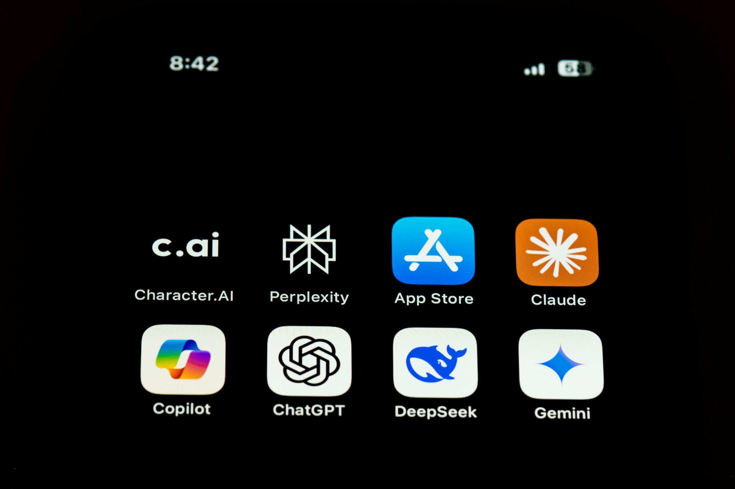 Mobile phone screen showing various app icons, including App Store, and AI tools.