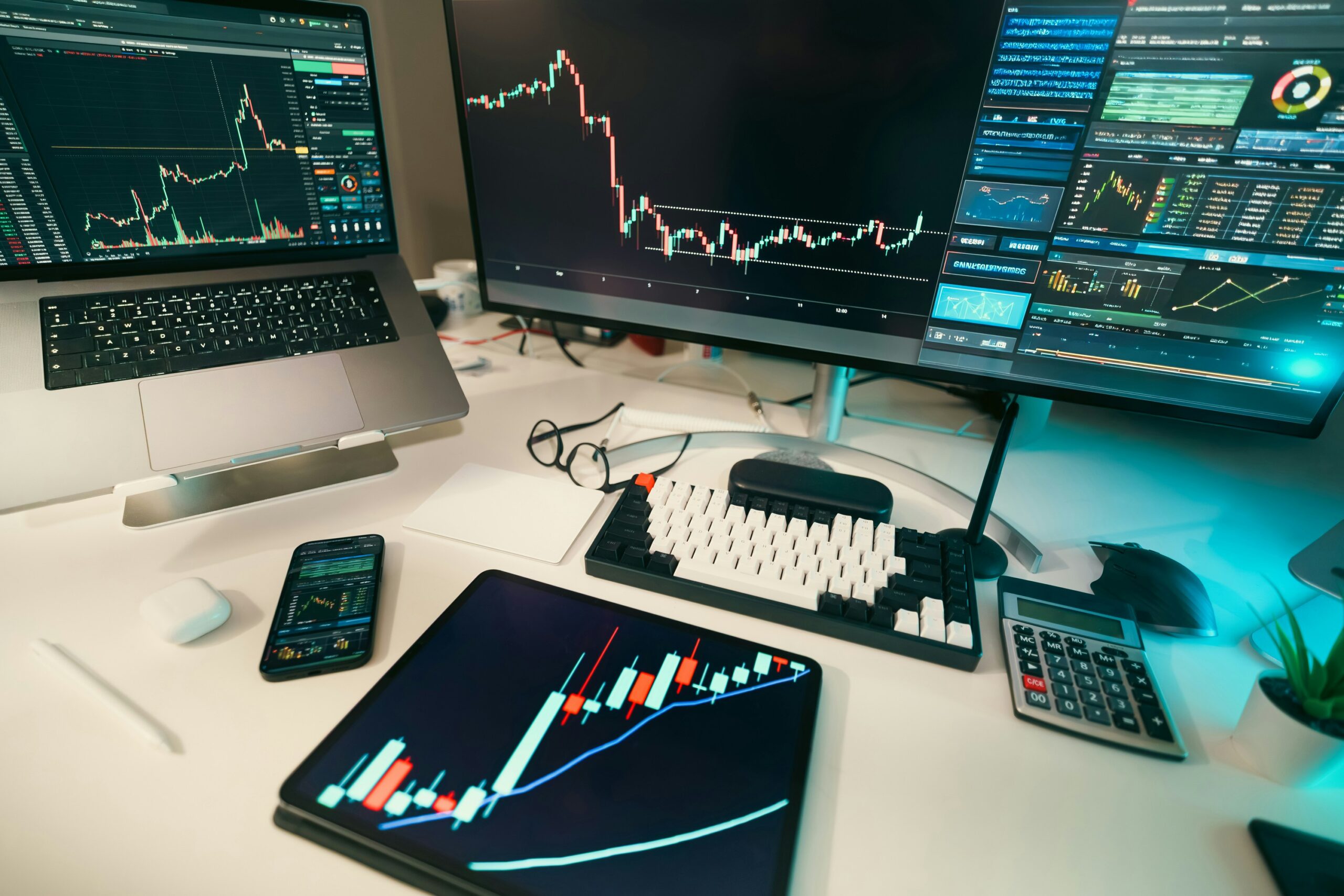 Workspace with multiple screens displaying stock market data.