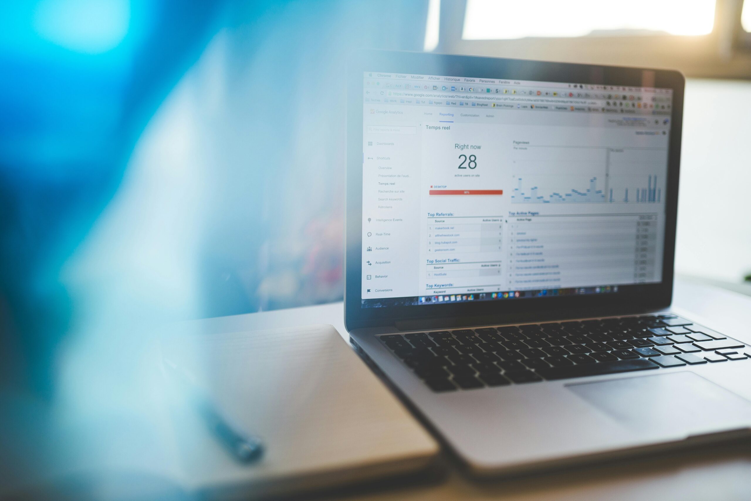 A close-up of a laptop screen displaying Google Ads data and analytics, with a graph showing campaign performance and trends. The scene should convey a sense of data analysis and strategic planning.