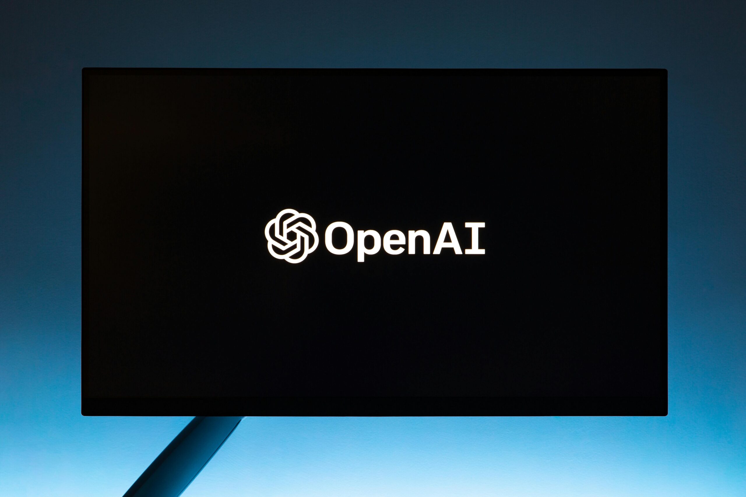 OpenAI logo on a black screen, representing artificial intelligence.
