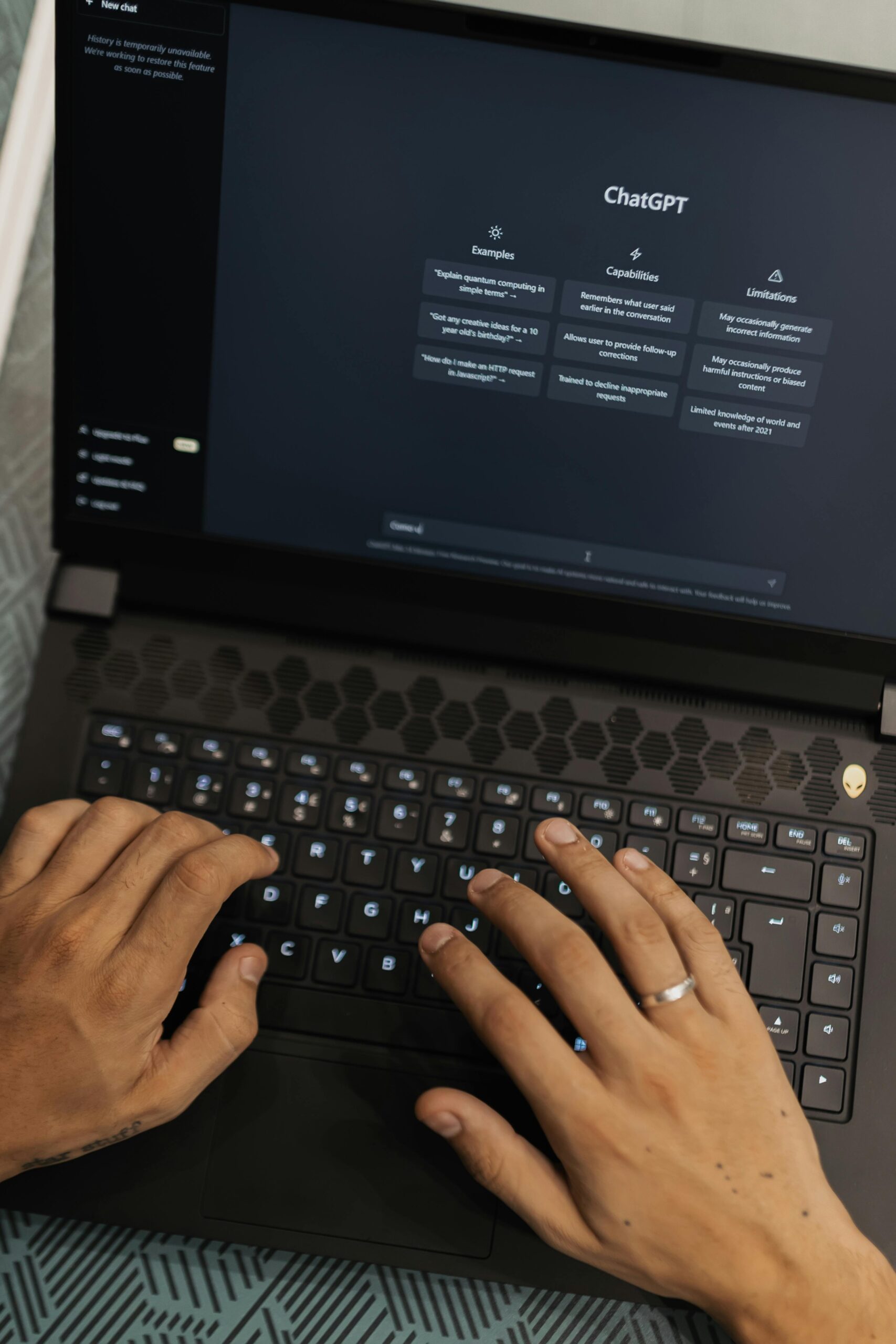 Hands typing on a laptop with AI prompts visible.