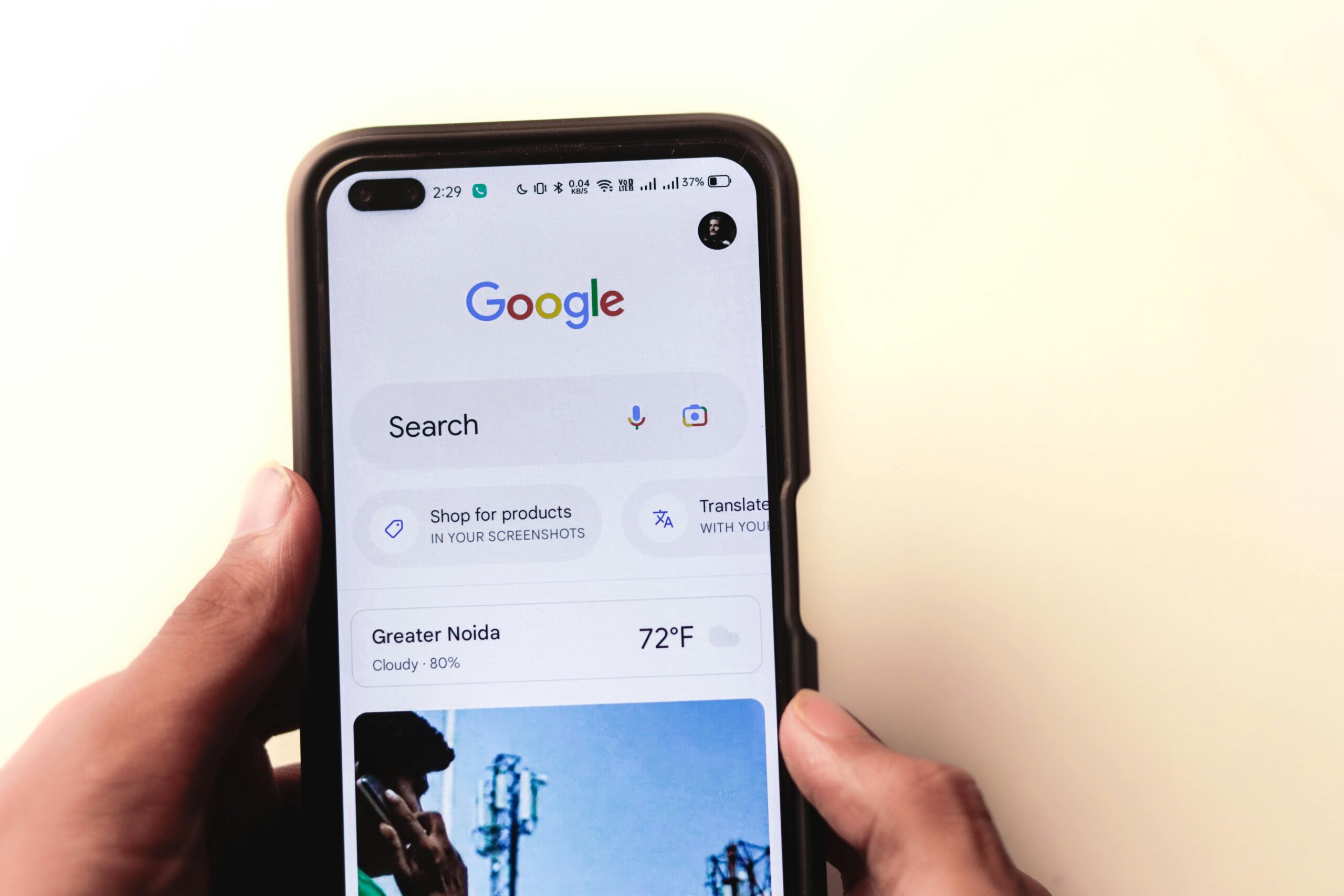 Smartphone displaying Google search results, Greater Noida weather.