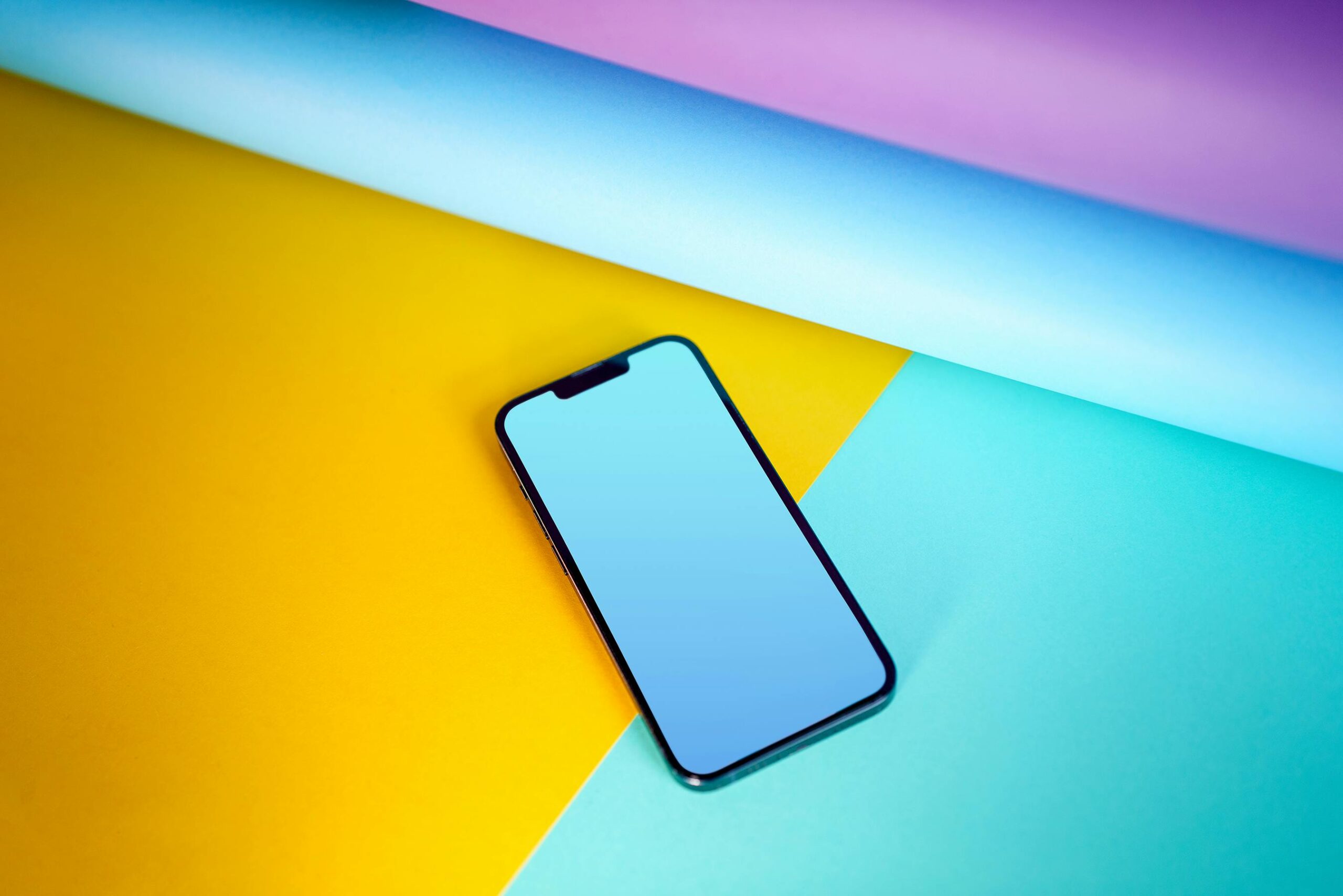 Smartphone with blank screen on colorful background.