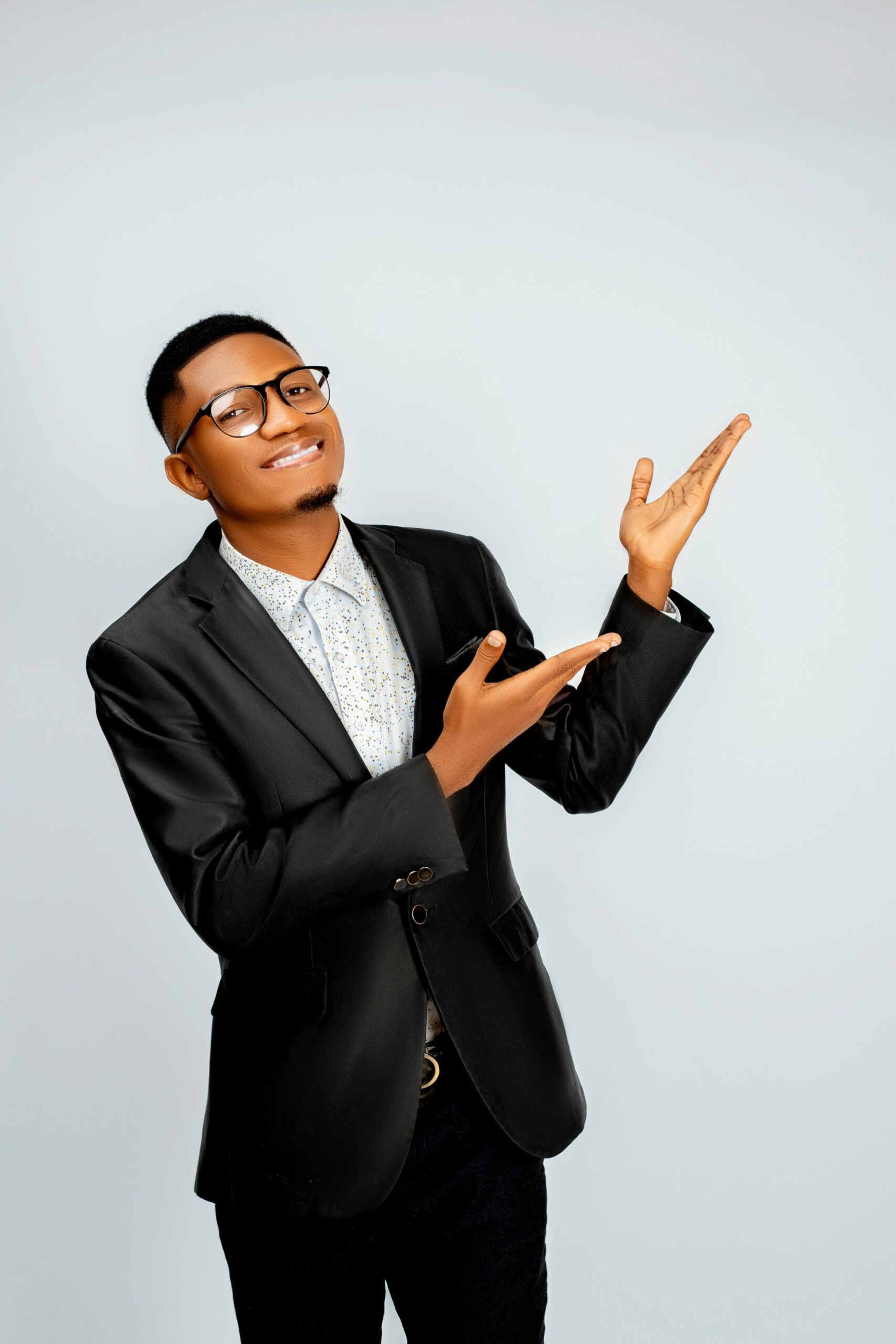 A man in a suit gesturing and smiling, suitable for Facebook ads guide or marketing.