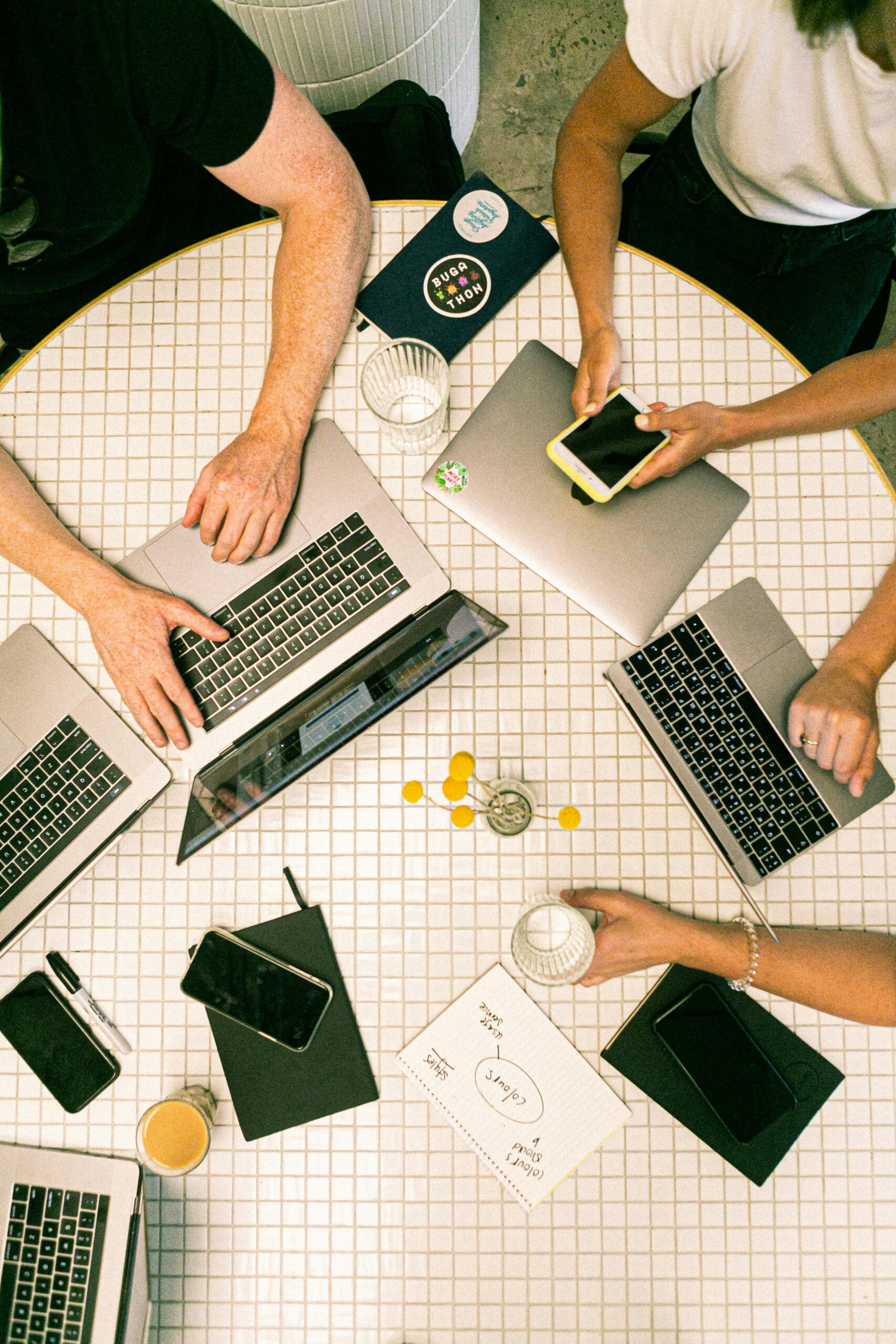 A group of marketing professionals brainstorming in a creative office space, whiteboard with ideas, colorful sticky notes, natural light, and a relaxed atmosphere.