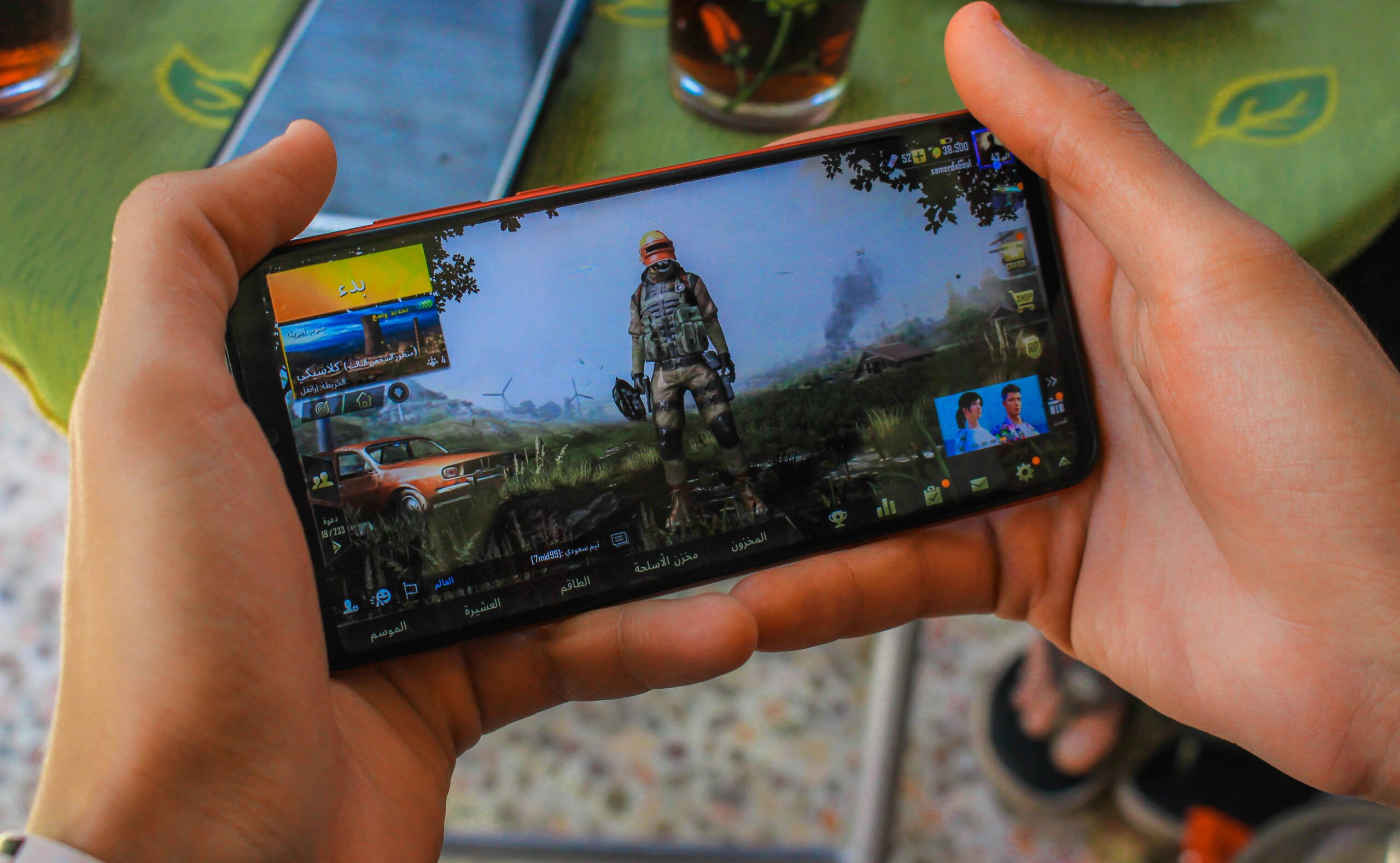 Person holding a phone displaying a mobile game. Related to Digital Marketing and AI.