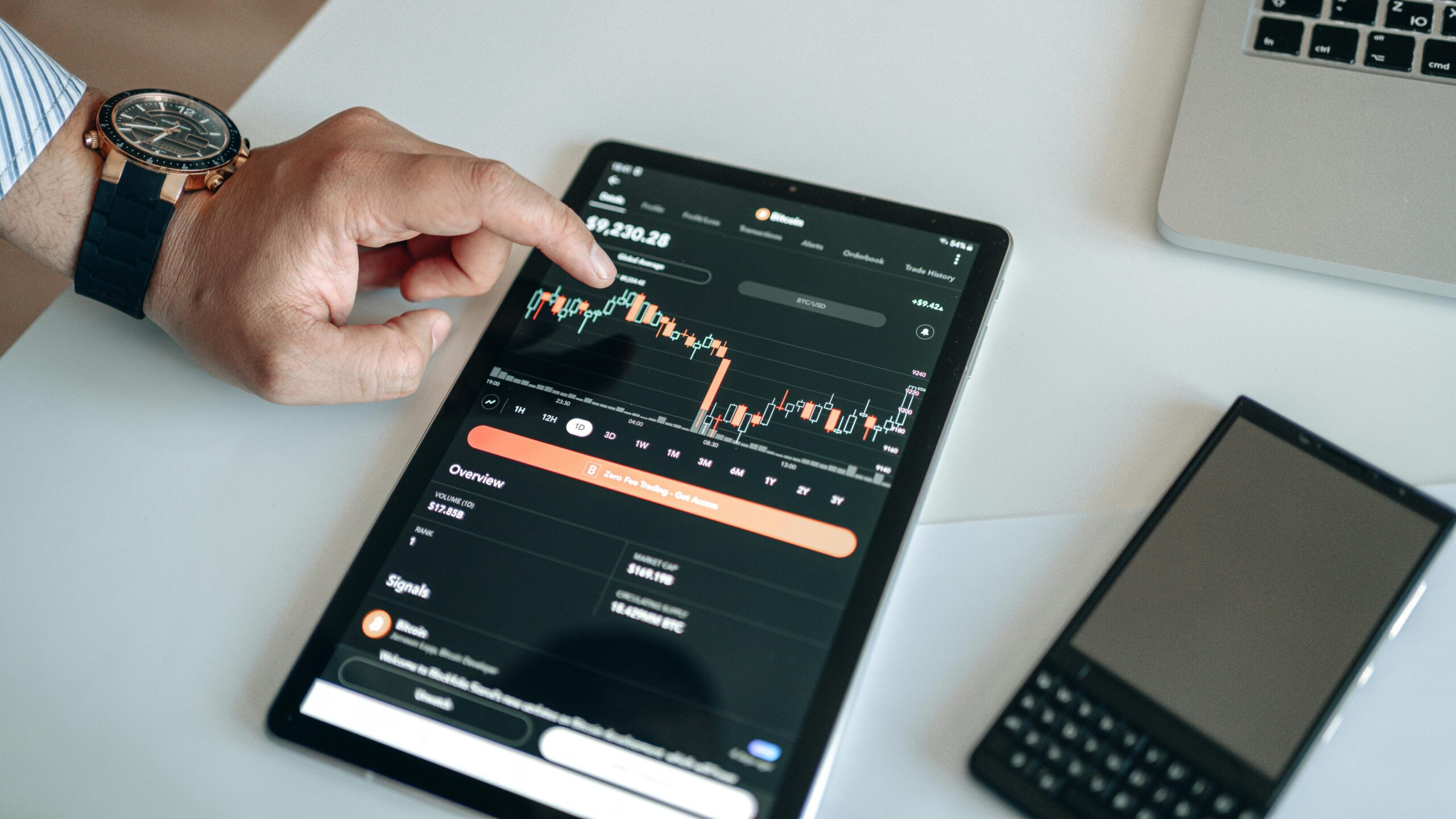 Person using a tablet to monitor Bitcoin cryptocurrency trading.