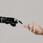 Robot hand reaching towards a human hand, symbolizing AI collaboration.