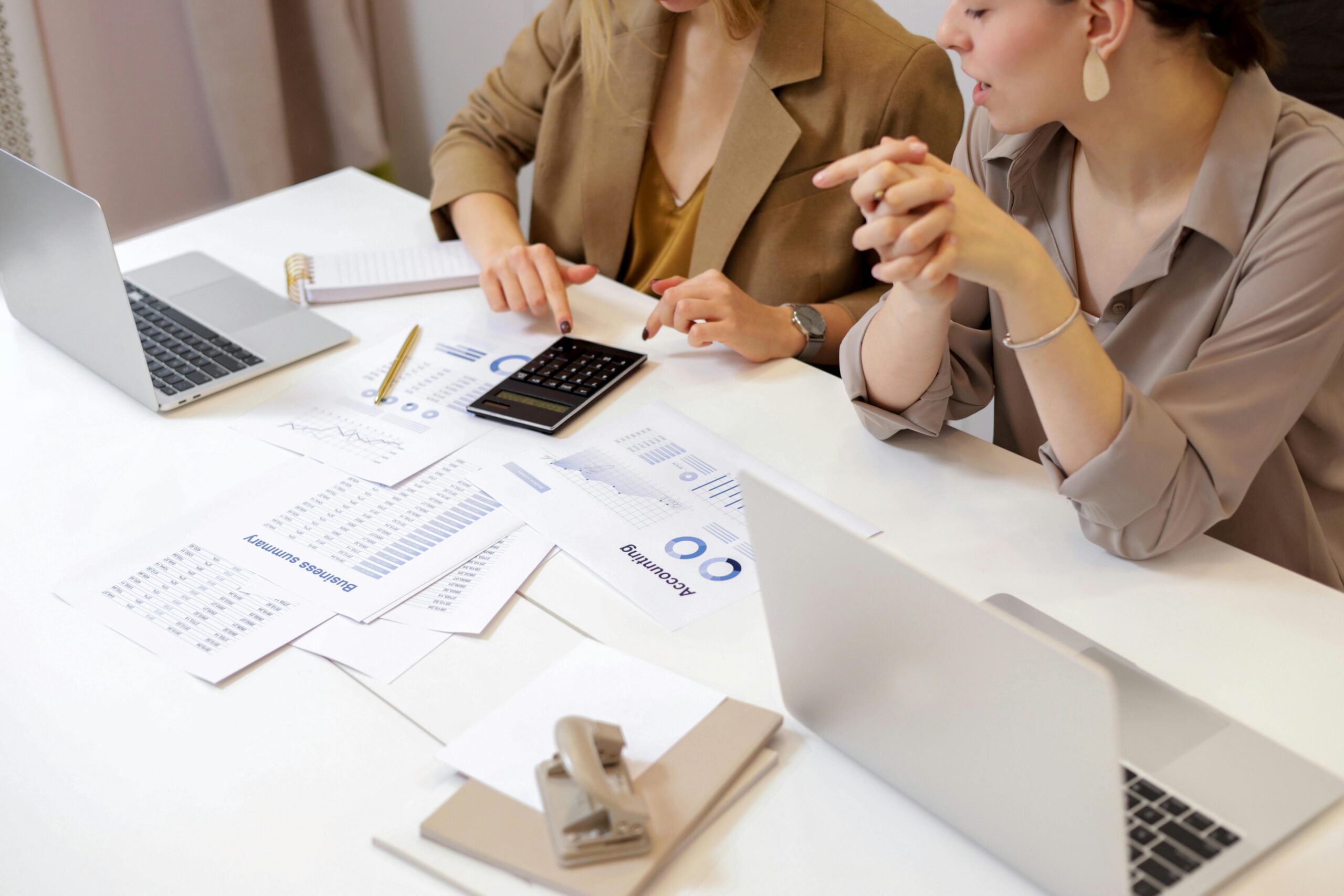 A person using a laptop and analyzing data, with a background that suggests a modern and dynamic office environment with a focus on digital marketing and data analytics.
