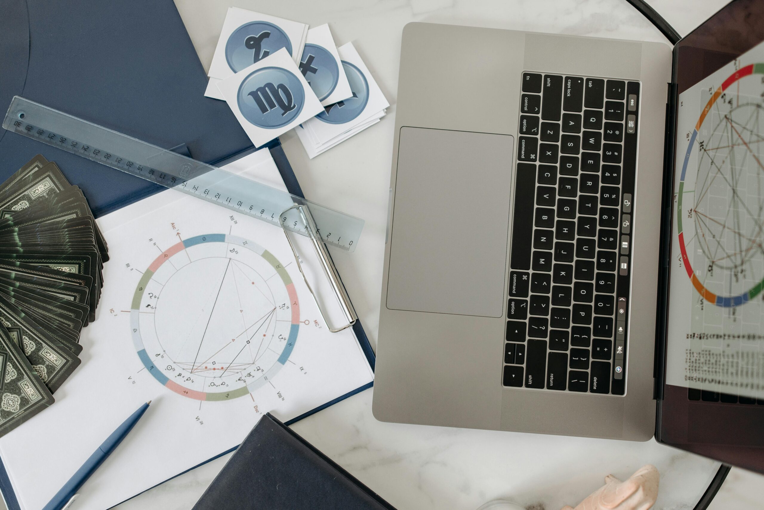 Laptop, charts, and documents on a desk. Digital marketing strategy planning.