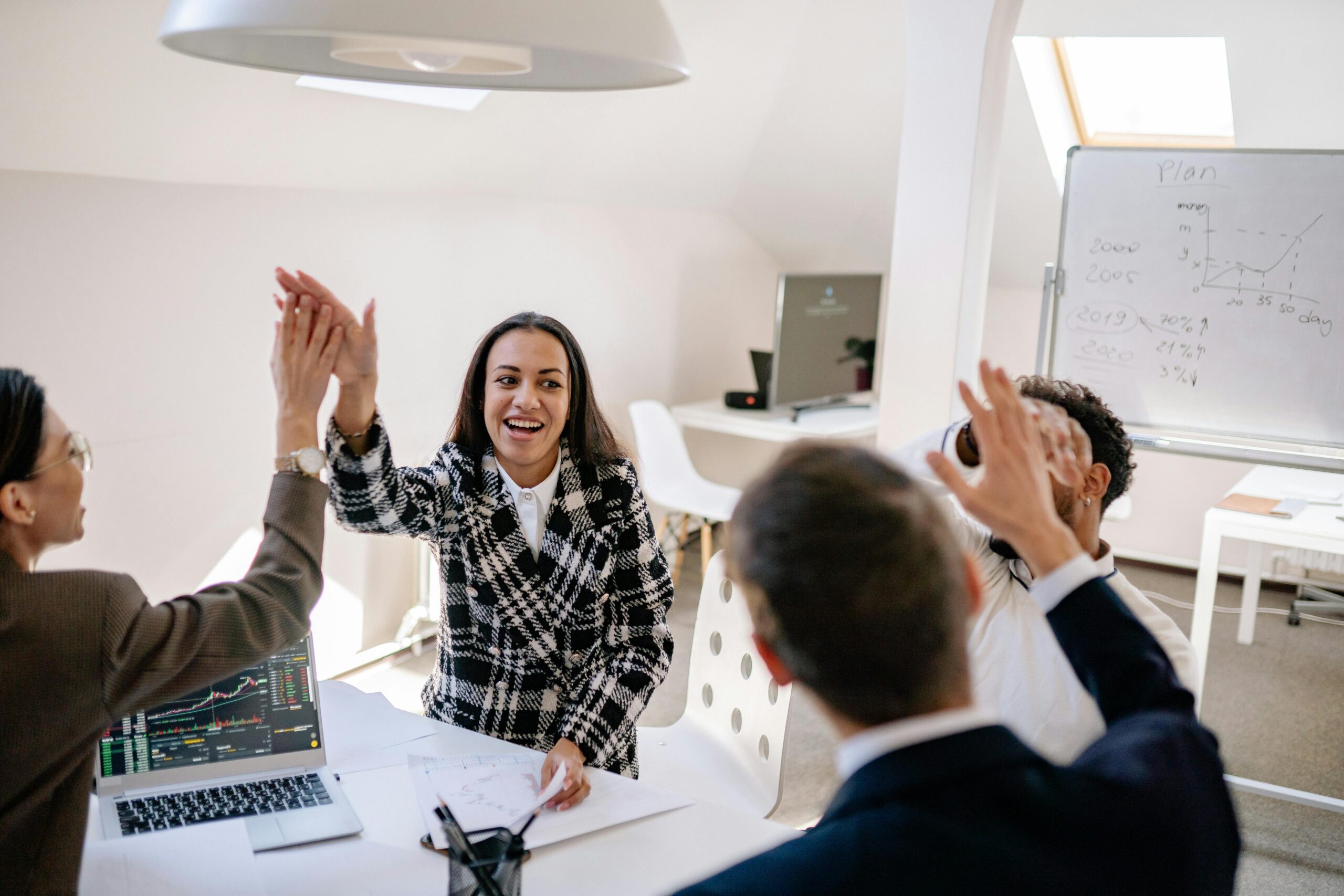 Business team celebrating success with a high five.