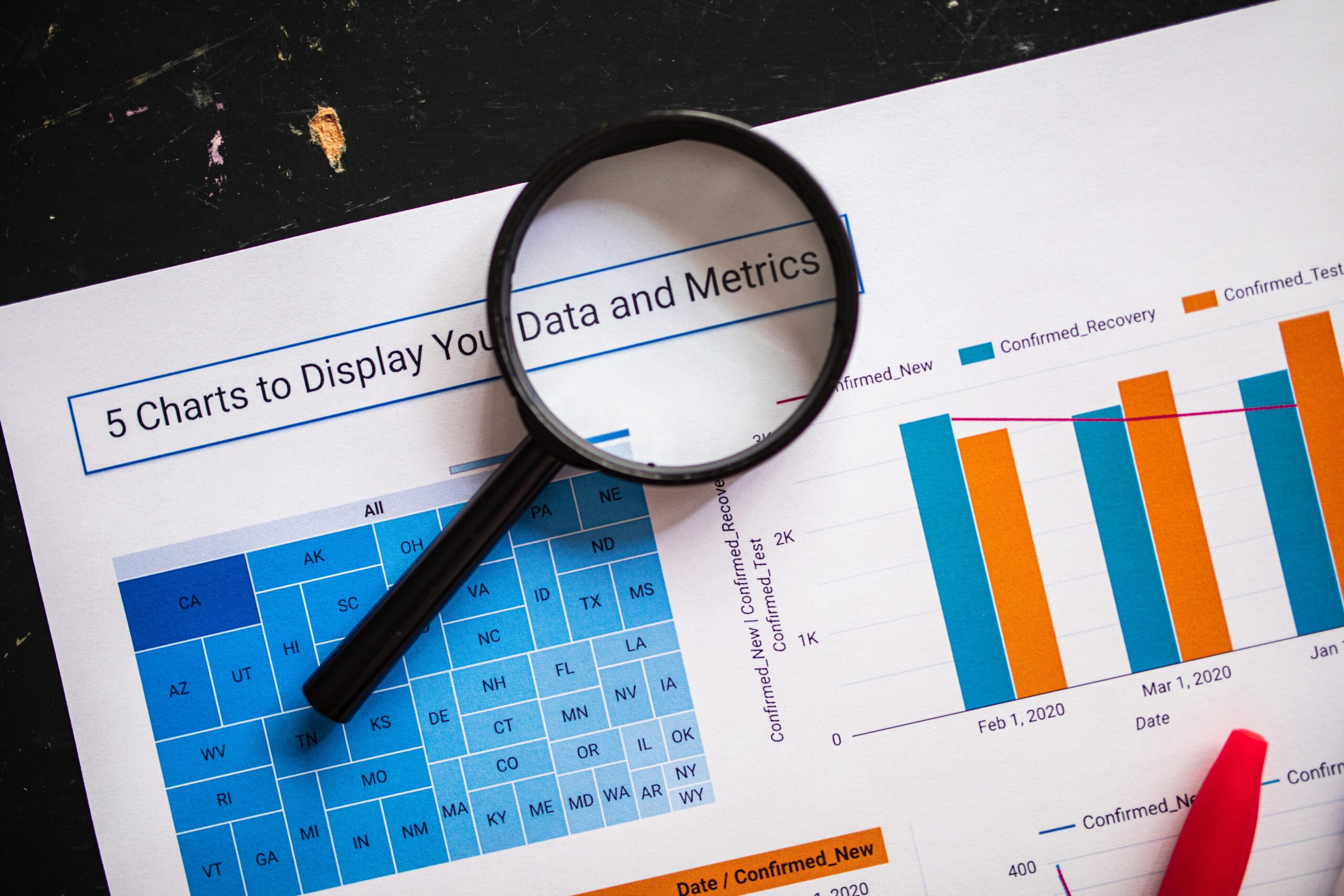Magnifying glass over a graph showing data and metrics.