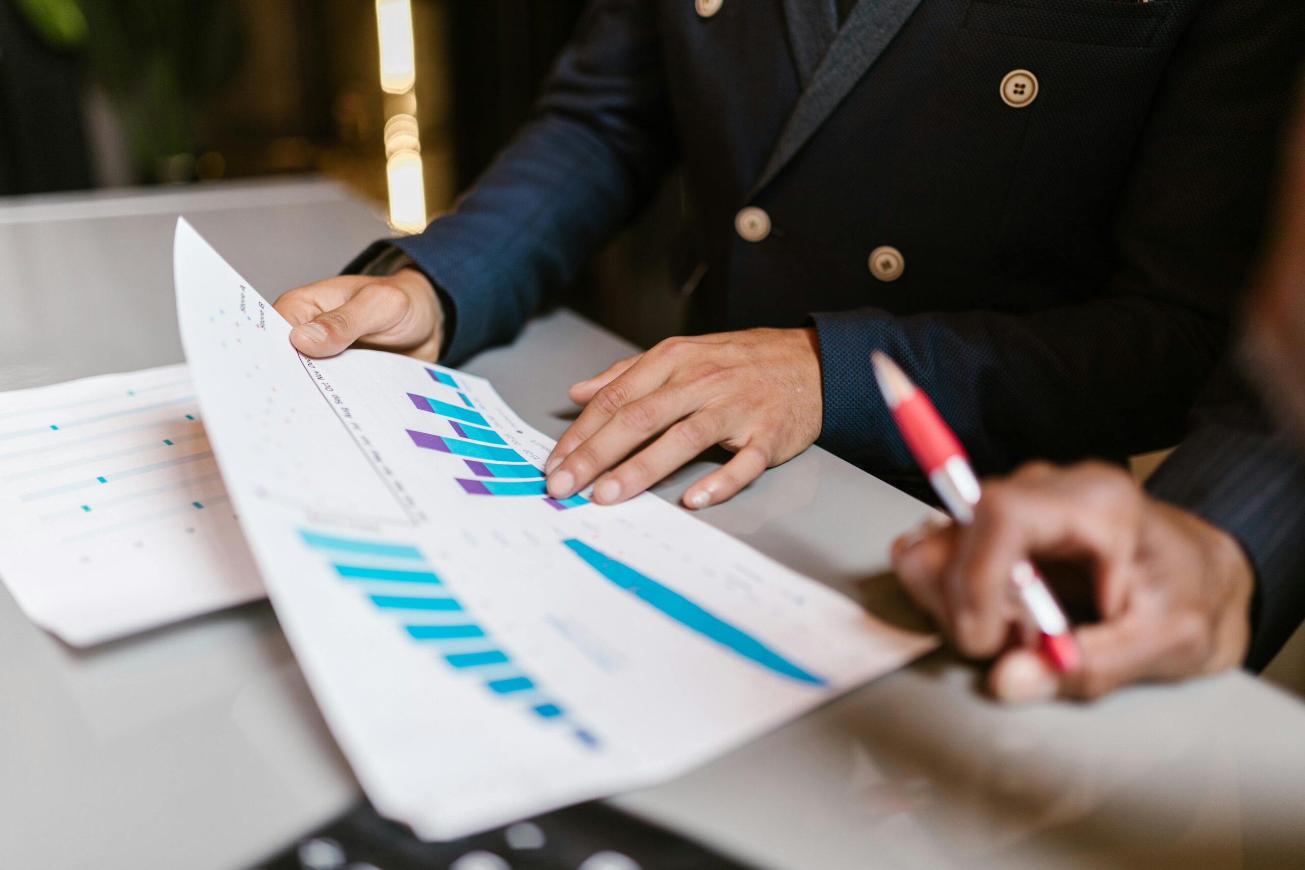 Businesspeople reviewing marketing strategy charts and graphs.