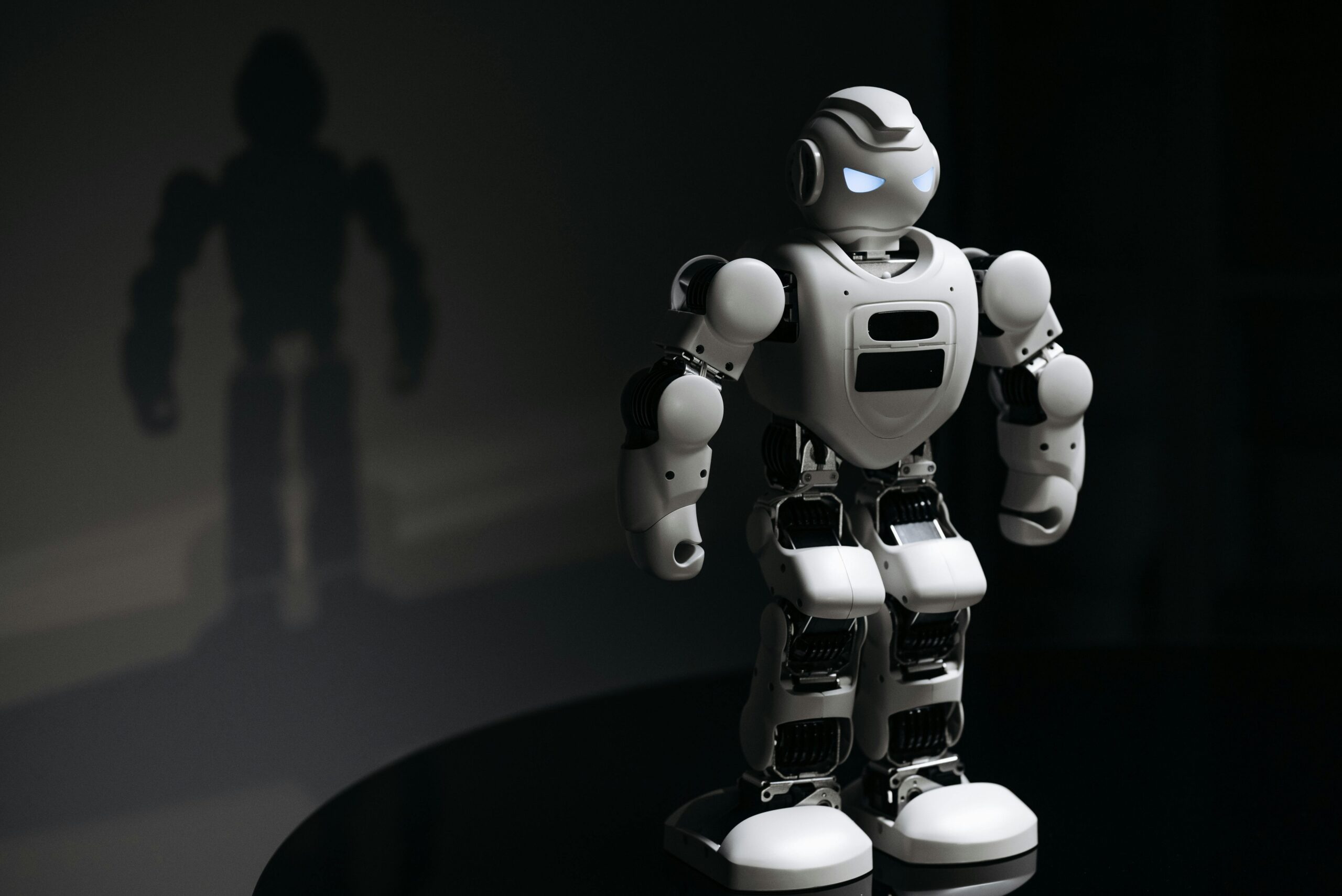 White robot with glowing eyes, representing Artificial Intelligence.