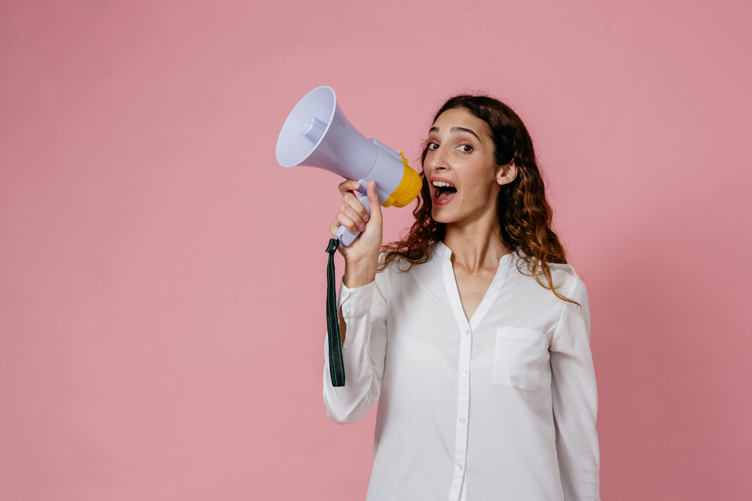 Woman using megaphone, announcing something. Marketing and communication.
