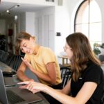A vibrant office scene with digital marketing professionals collaborating on strategies, data charts displayed on screens, and diverse team members brainstorming ideas, reflecting innovation and success.