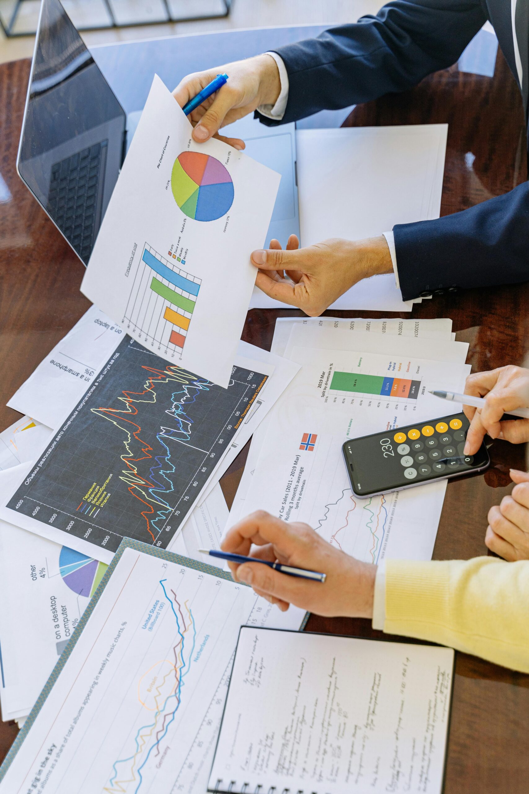 A satisfied business owner or marketing director reviewing a performance report with a digital marketing consultant, both smiling and pointing at positive growth trends on the screen. The setting is a modern office, with a focus on trust and partnership.