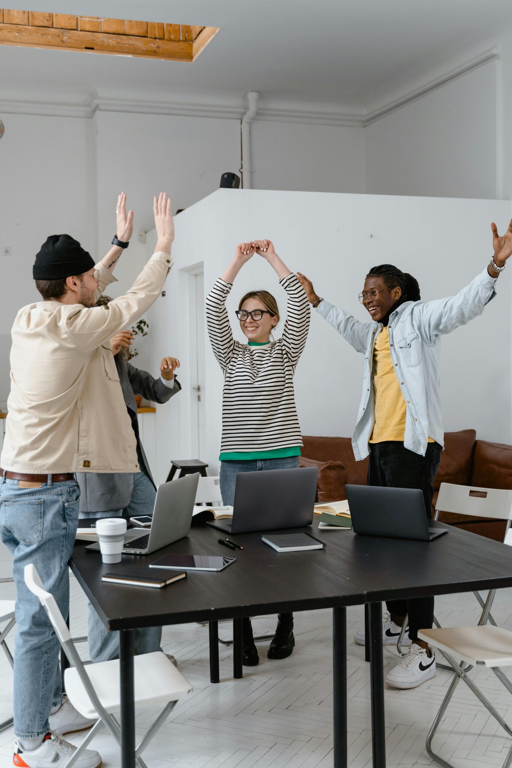 A group of business professionals celebrating a successful marketing campaign, symbolizing the positive impact of a strategic partnership with a marketing agency.