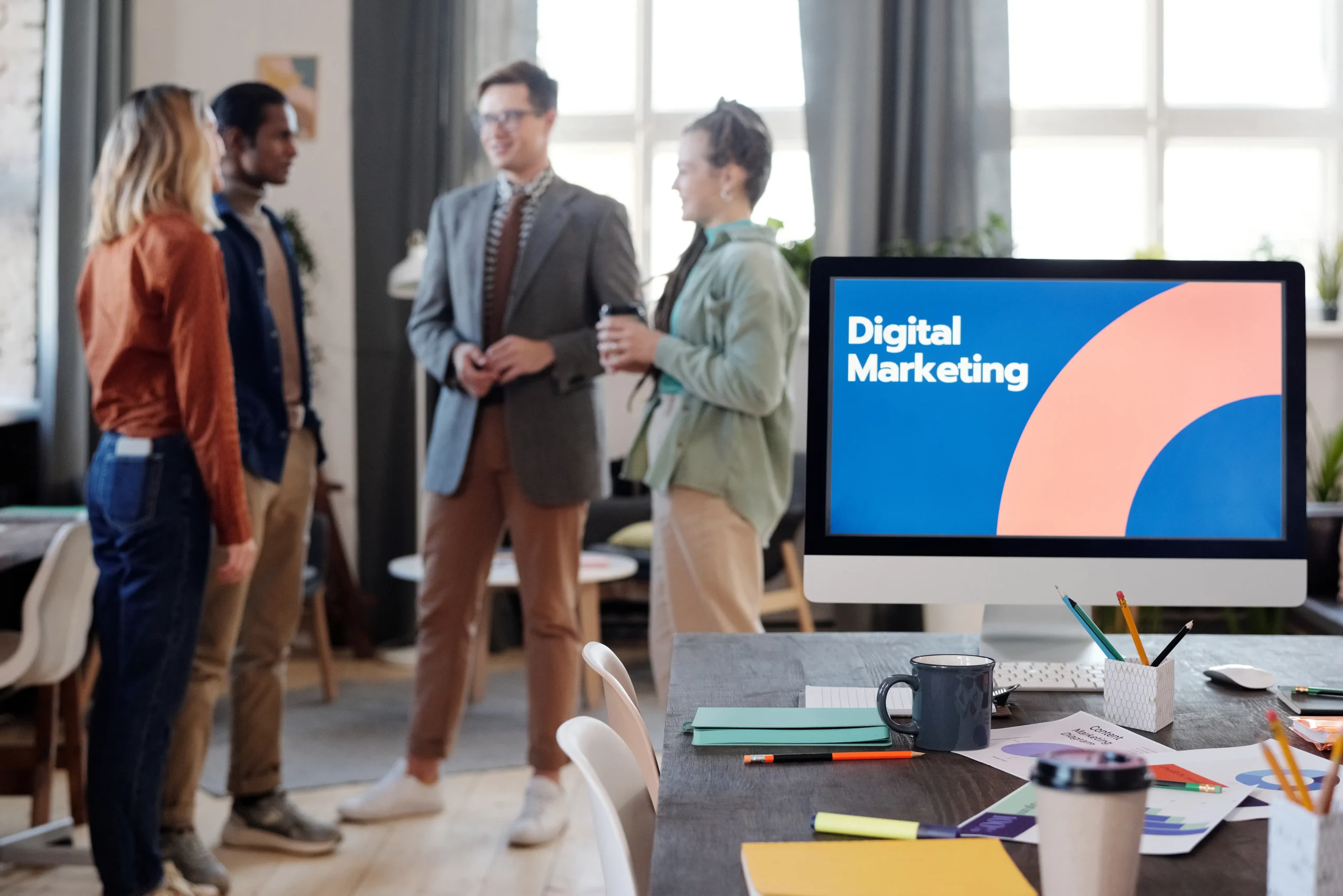 A team of digital marketing professionals collaborating on a project, showcasing the expertise offered by a digital marketing agency. Description: A collaborative digital marketing agency team devising strategies to improve online audience reach and drive business growth.