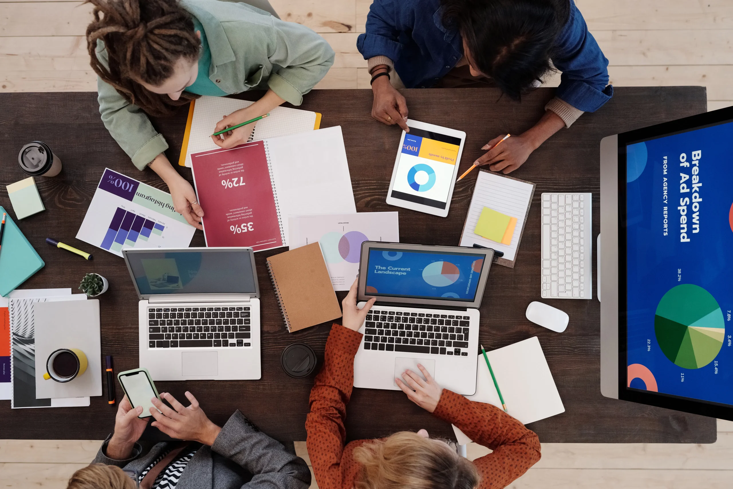 A diverse group of digital marketers collaborating on a strategy board, highlighting the collaborative and analytical nature of crafting effective digital marketing solutions. Keywords: 