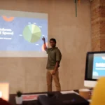 A dynamic image showcasing a diverse team of Meta ads experts collaborating on a project, with charts and graphs illustrating successful ad campaigns and ROI optimization.