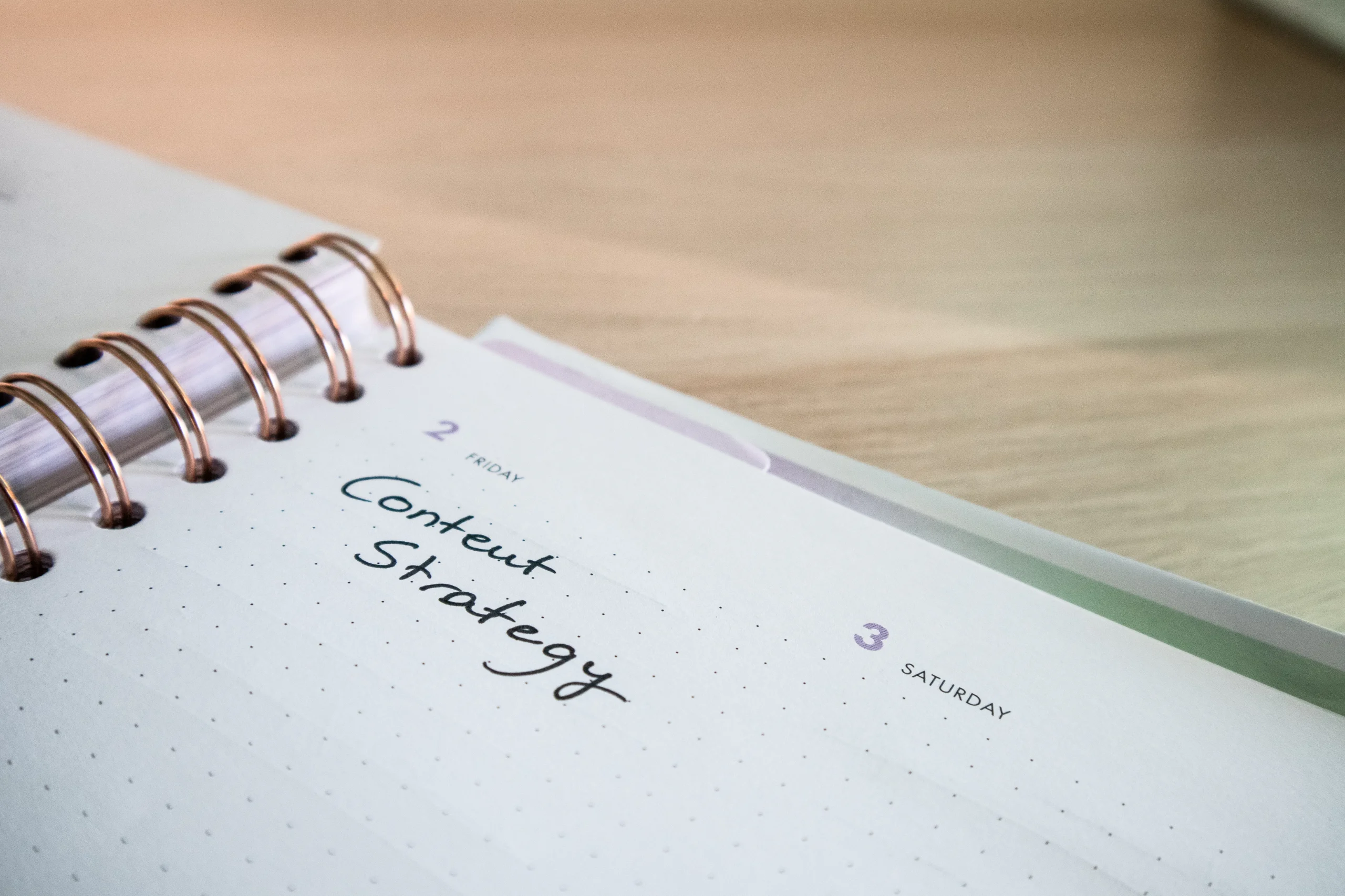 Content Strategy is written on a notepad, indicative of planning for native content or native advertising campaigns.