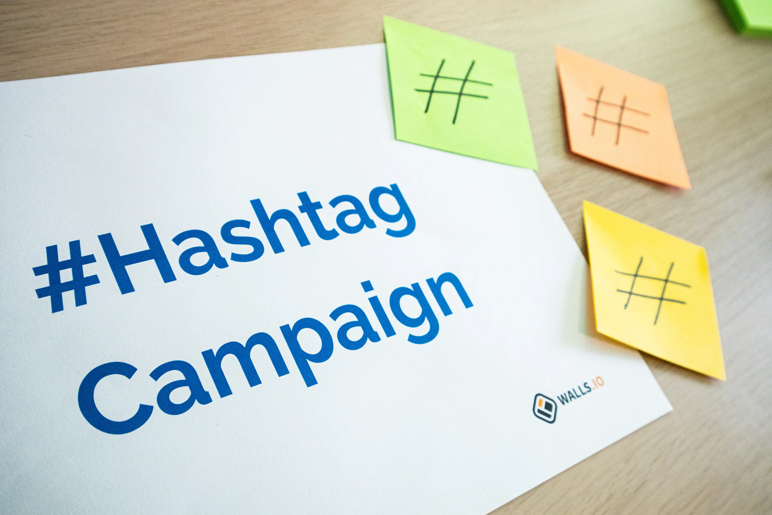 A close-up of a sign that reads '#Hashtag Campaign', highlighting a digital advertising tip for increasing click-through rate in native ads platforms.