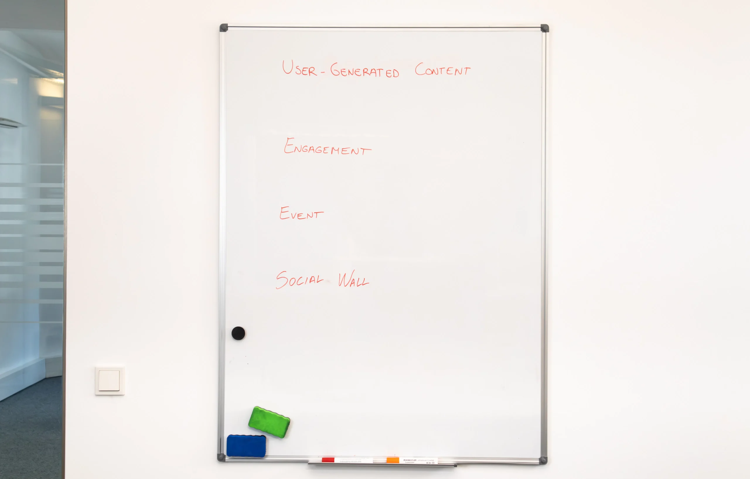A whiteboard displays the terms 'User-Generated Content,' 'Engagement,' 'Event,' and 'Social Wall,' representing strategies for native content marketing and native ads platforms.