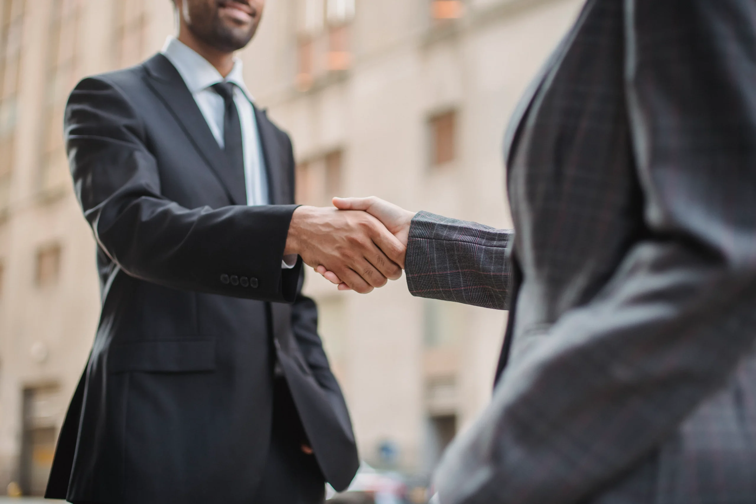 Business handshake between client and native advertising agency representative
