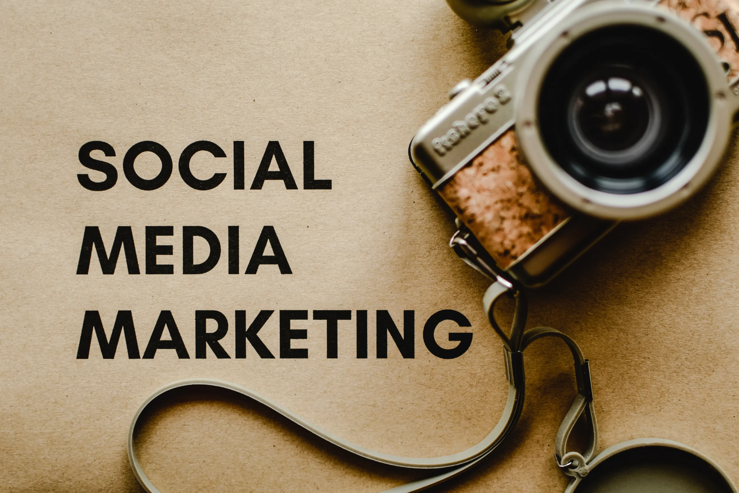 Social media marketing text next to a vintage camera, referencing social media marketing company in UK.