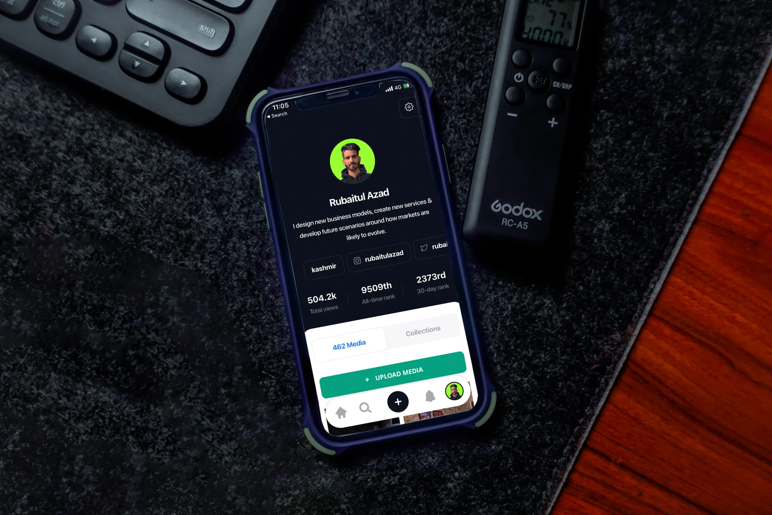 Smartphone displaying a profile, next to a keyboard, useful for social media marketing company in UK.